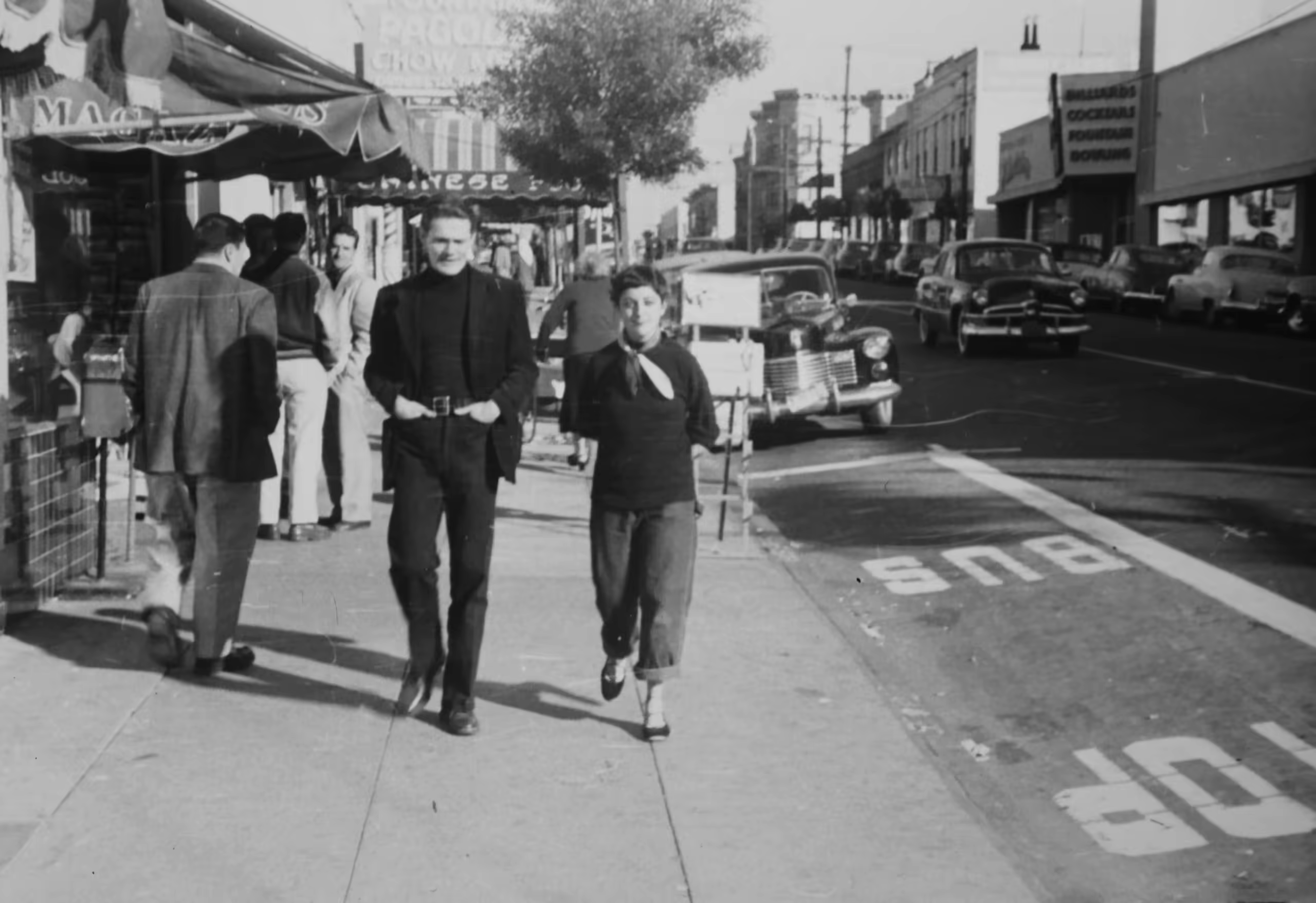Historic street scene with three people